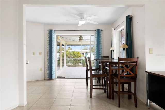 dining space with ceiling fan and light tile patterned floors