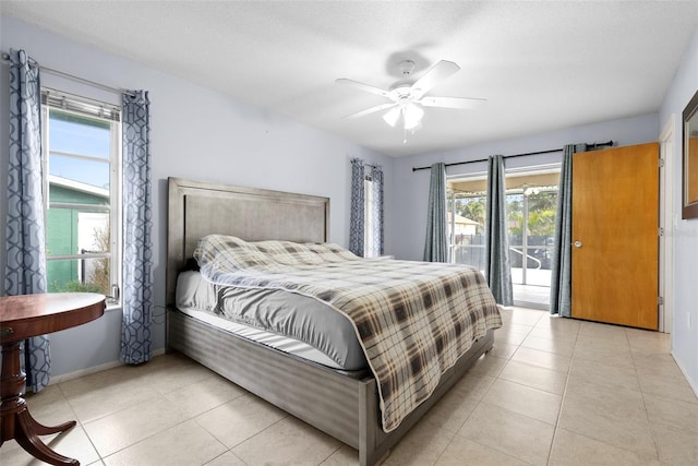 tiled bedroom with a textured ceiling, access to exterior, and ceiling fan