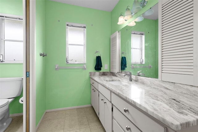 bathroom with vanity, tile patterned flooring, and toilet