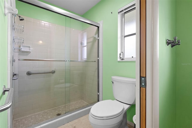 bathroom featuring an enclosed shower and toilet