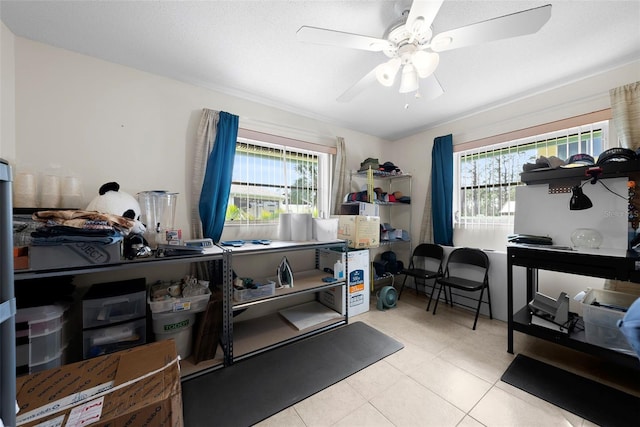 misc room with ceiling fan, light tile patterned floors, and a wealth of natural light