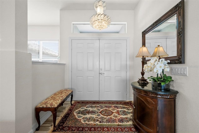 foyer with a chandelier