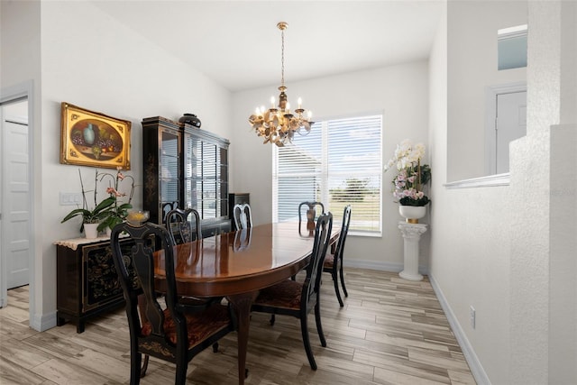 dining room with an inviting chandelier and light wood-type flooring