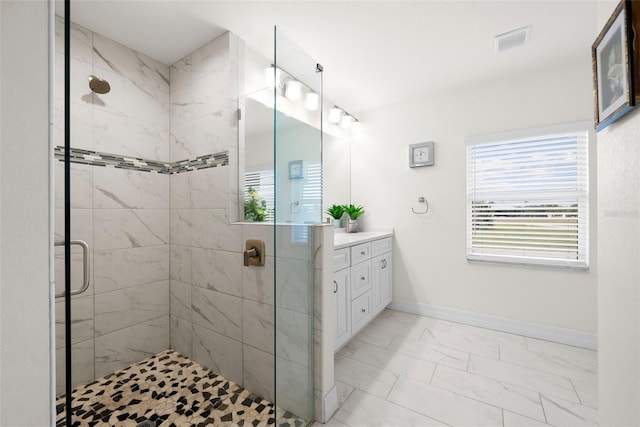 bathroom with vanity and a shower with shower door