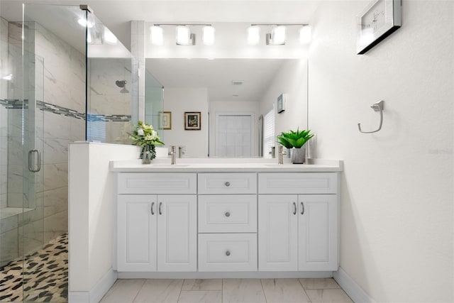 bathroom featuring vanity and a shower with door