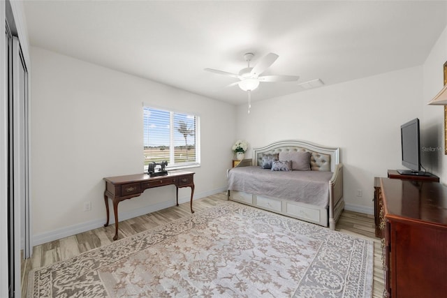 bedroom with wood-type flooring, a closet, and ceiling fan