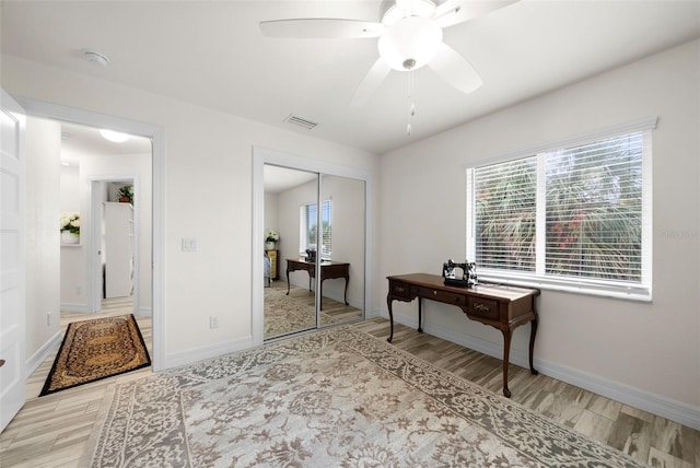 office space with light hardwood / wood-style flooring and ceiling fan