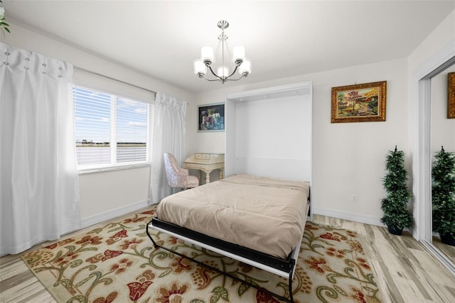 bedroom featuring a notable chandelier and light wood-type flooring