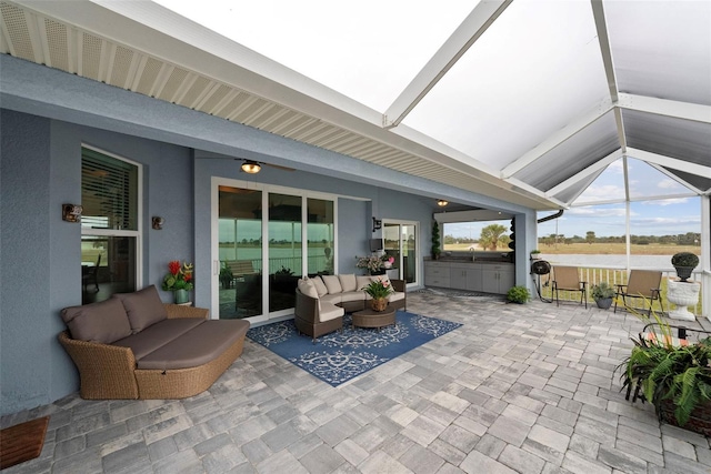 view of patio / terrace with an outdoor hangout area and glass enclosure