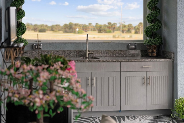 details with dark stone countertops and sink