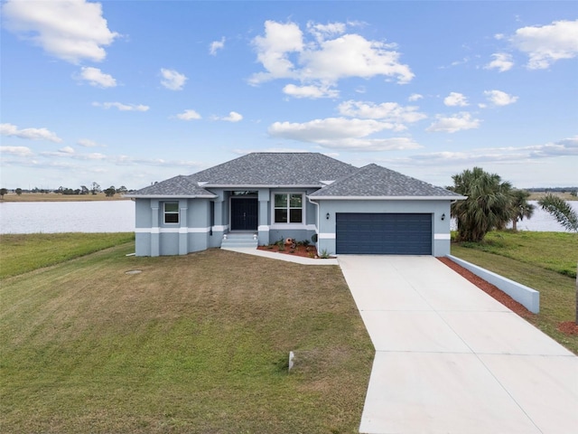 view of front of property with a water view, a garage, and a front yard