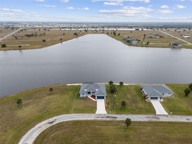 drone / aerial view with a water view and a rural view