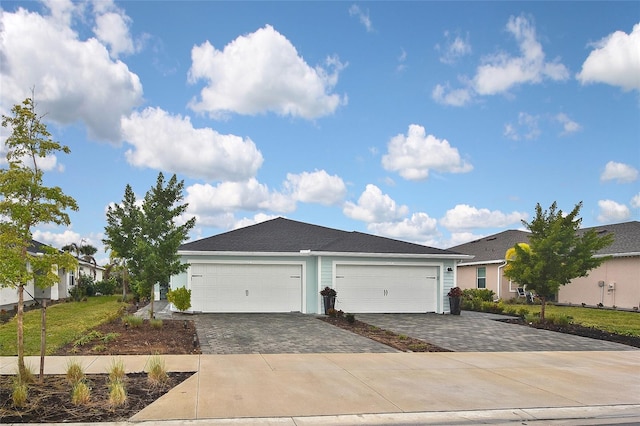 view of front of property with a front lawn and a garage