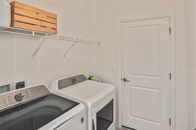 laundry room featuring washing machine and clothes dryer