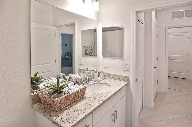 bathroom with tile patterned flooring and vanity