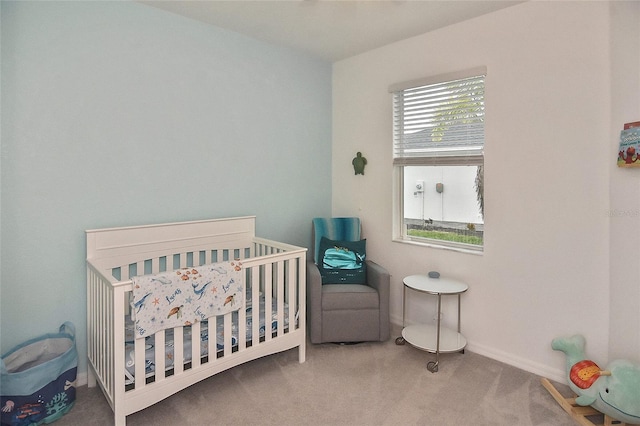 carpeted bedroom with a nursery area