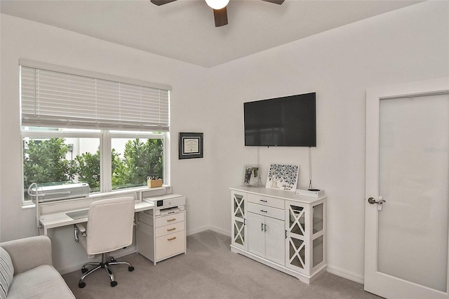 home office with light carpet and ceiling fan