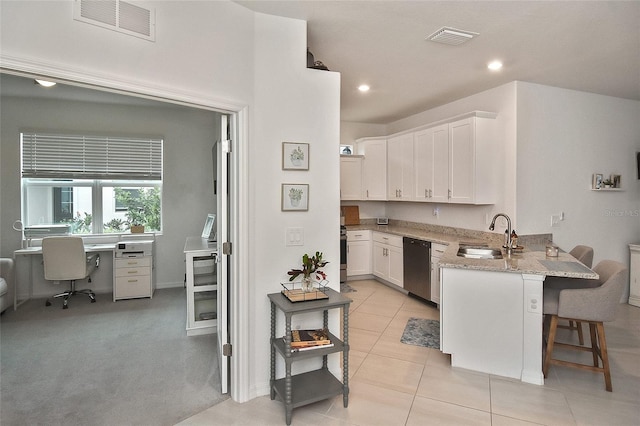 kitchen with a kitchen bar, kitchen peninsula, sink, dishwasher, and white cabinets