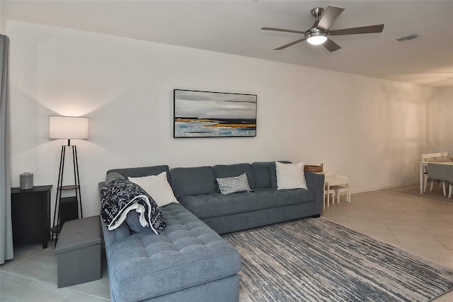 living room featuring tile patterned flooring and ceiling fan