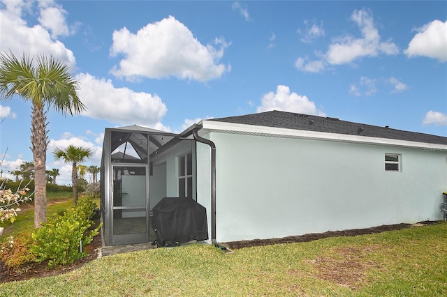 view of home's exterior with a yard and a lanai