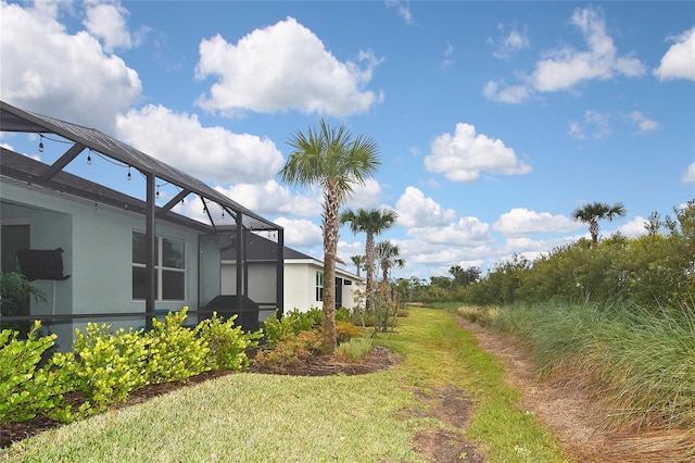 view of yard featuring glass enclosure