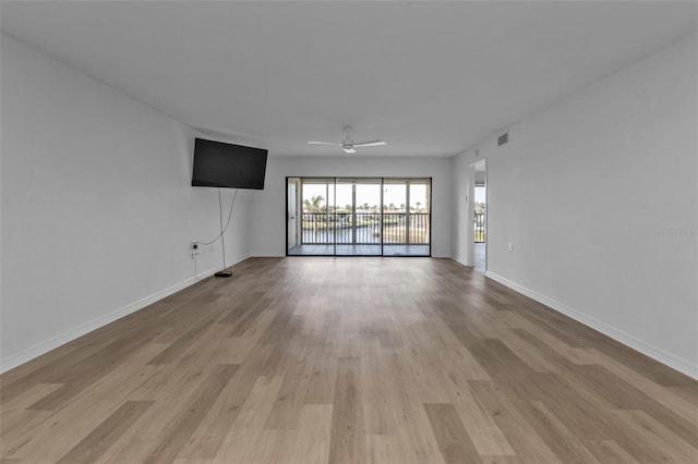 unfurnished living room featuring ceiling fan and light hardwood / wood-style flooring