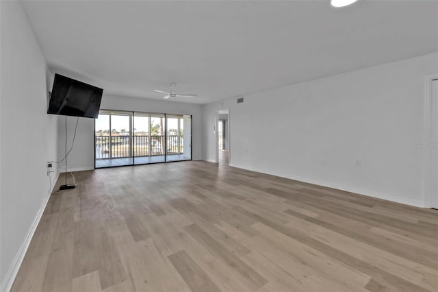 unfurnished living room featuring light hardwood / wood-style flooring and ceiling fan