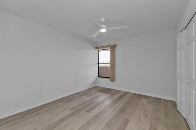 unfurnished bedroom with ceiling fan, light hardwood / wood-style floors, and a closet