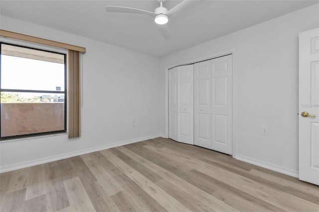 unfurnished bedroom featuring a closet, light hardwood / wood-style flooring, and ceiling fan