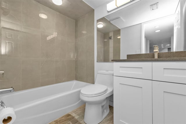 full bathroom featuring vanity, toilet, and tiled shower / bath combo