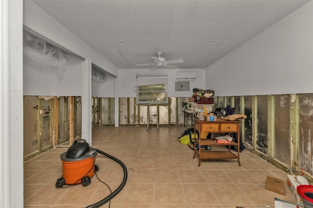 misc room featuring ceiling fan, light tile patterned flooring, and a wall mounted AC