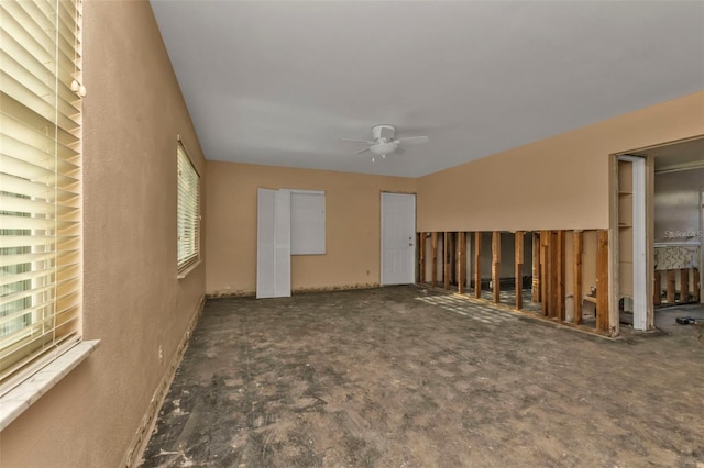 interior space with ceiling fan