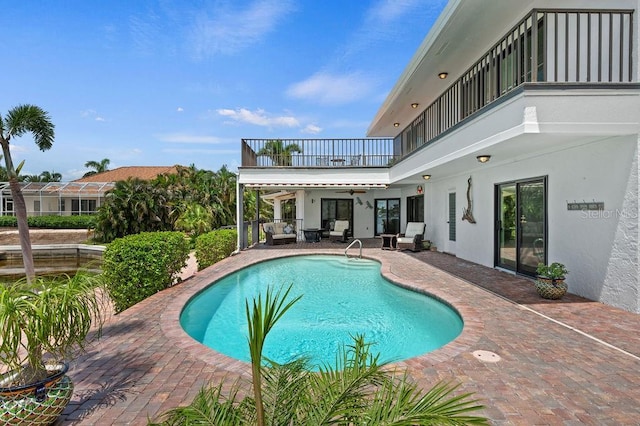 view of pool featuring a patio and ceiling fan