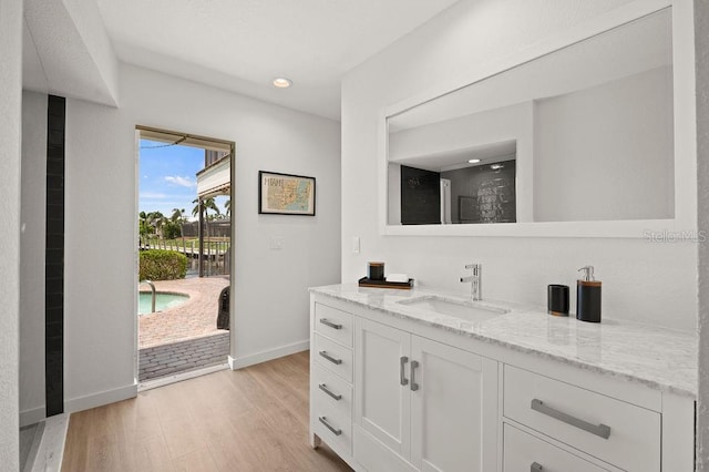 bathroom with hardwood / wood-style flooring and vanity