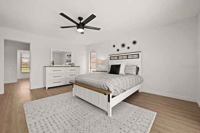 bedroom with light hardwood / wood-style flooring and ceiling fan