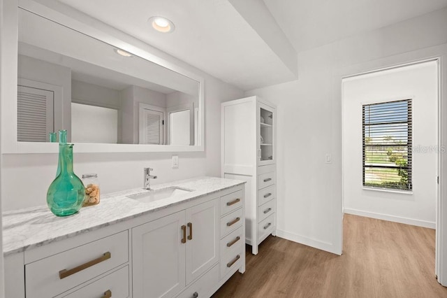 bathroom with hardwood / wood-style flooring and vanity