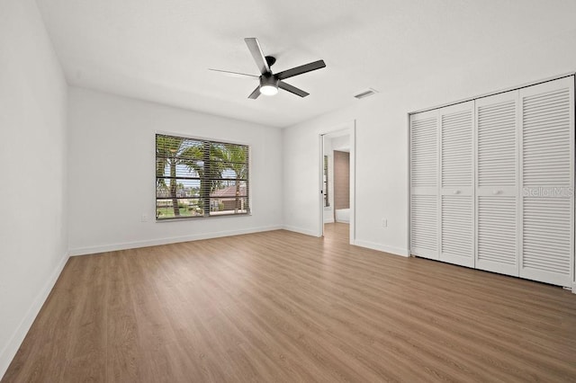 unfurnished bedroom featuring a closet, ceiling fan, and hardwood / wood-style floors