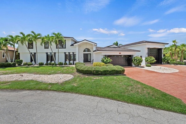 view of front of property featuring a front yard and a garage