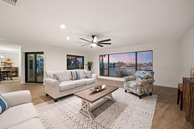 living room with ceiling fan and hardwood / wood-style floors