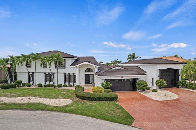 view of front of home with a garage and a front yard