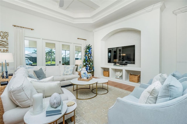 living room featuring ornamental molding, french doors, coffered ceiling, and hardwood / wood-style floors