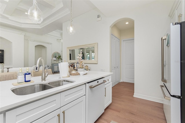 kitchen with white appliances, white cabinetry, sink, light hardwood / wood-style flooring, and decorative light fixtures