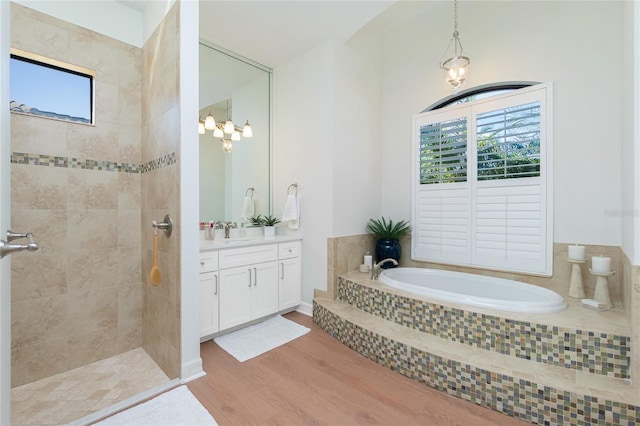 bathroom with independent shower and bath, vanity, hardwood / wood-style flooring, and a wealth of natural light