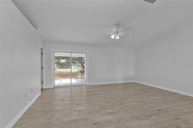 empty room with ceiling fan and light hardwood / wood-style flooring