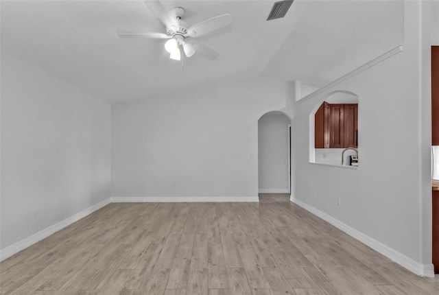 unfurnished living room with lofted ceiling, ceiling fan, and light wood-type flooring