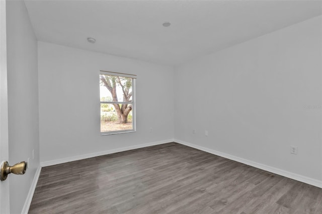 empty room featuring dark wood-type flooring