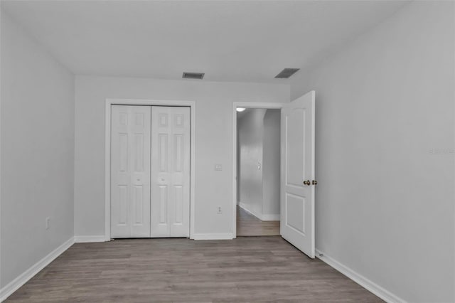 unfurnished bedroom featuring a closet and light hardwood / wood-style flooring