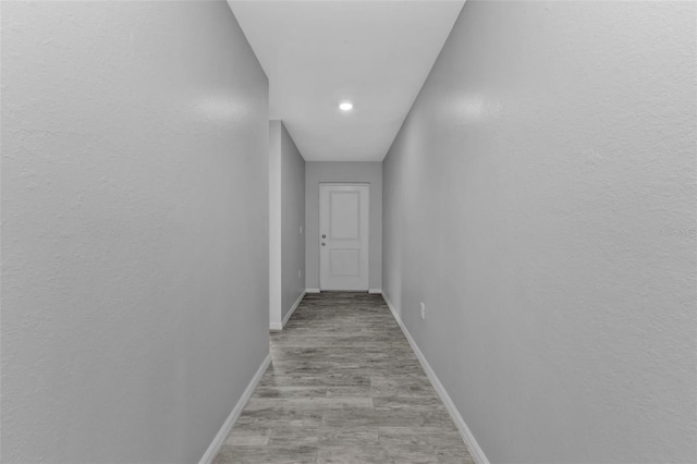 corridor with light hardwood / wood-style flooring