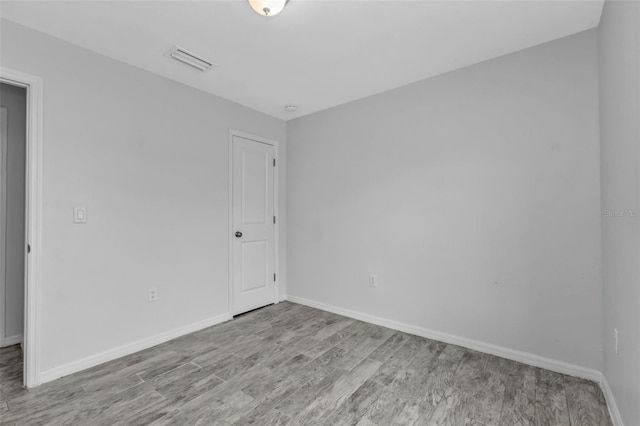 unfurnished room with light wood-type flooring