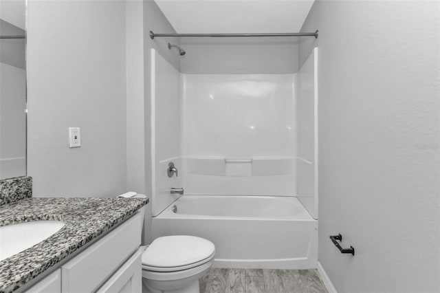 full bathroom featuring toilet, hardwood / wood-style floors, shower / washtub combination, and vanity